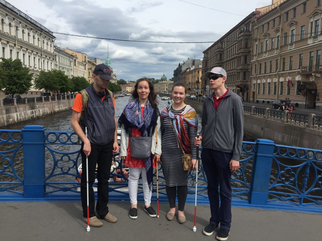 Laurel standing by the Neava River in St. Petersburg with Amy, Nikolai and Maksim.