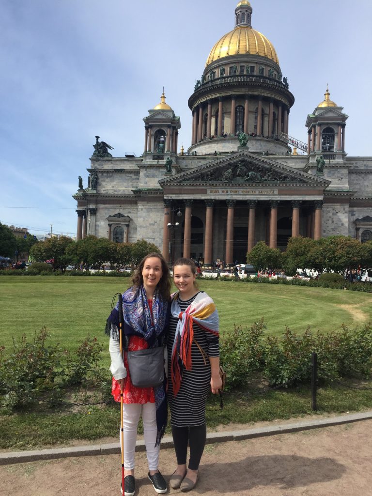 Laurel and her traveling companion Amy in front of Saint Isaac's Cathedral. The famous cathedral has a golden dome.