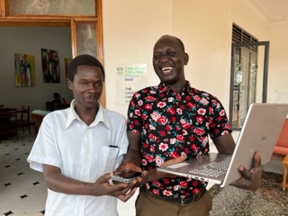 Patrick, a leader of the blind community in Gulu , Uganda smiles as he receives a new laptop computer and phone.