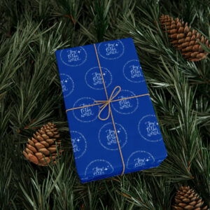 Blue Paper with Joy to the World design wrapping paper on a gift